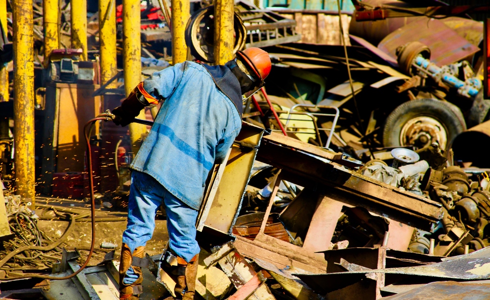 man learning how to scrap a car